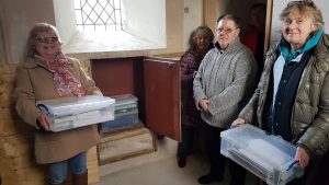 Olwen John, Pat Rowley, Rev’d Sarah Hildreth-Osborn and Janet Pierce place their time capsule boxes at St Grwst Church.